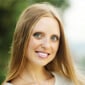 A woman with long hair smiling at the camera.